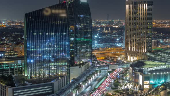 Dubai Downtown Street with Busy Traffic and Skyscrapers Around Night Timelapse