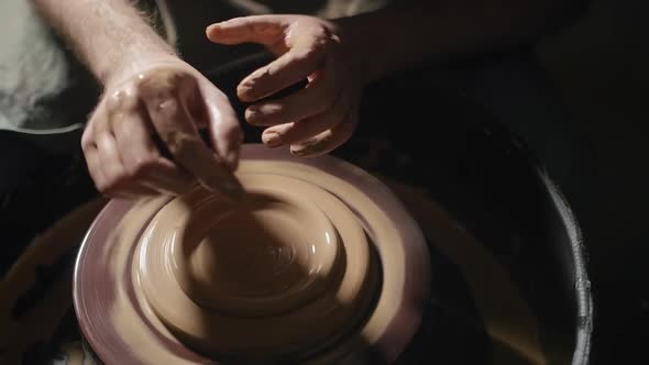 Artisan Hands Forming a Plate From Clay on a Potter's Wheel in Slow Motion