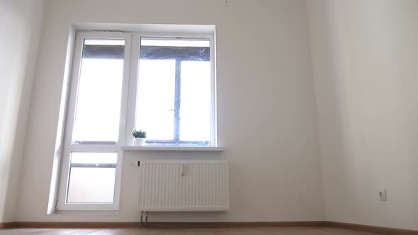 Interior of Empty Unfurnished Room with Walls Window and Radiator
