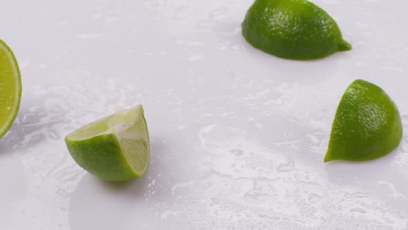 Lime Divided Into Slice on a White Background. Slow Motion