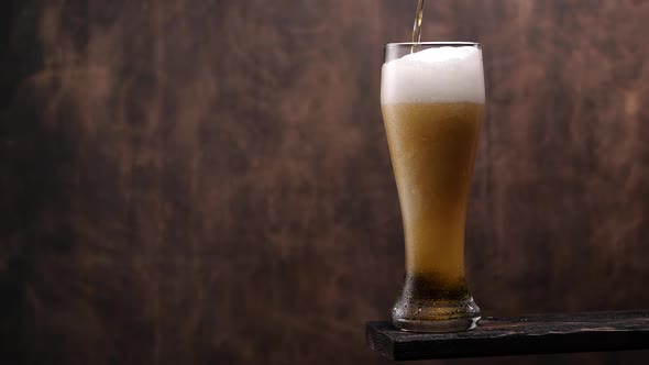 Fresh Beer Pouring Into Glass