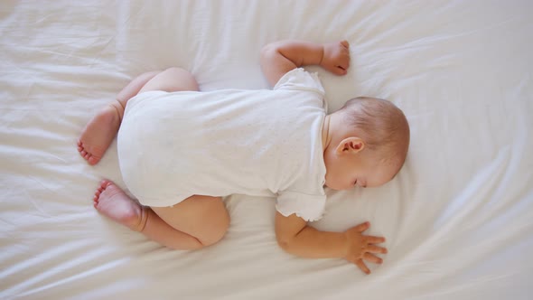 Peaceful Baby Girl Sleeping on Bed in a Room