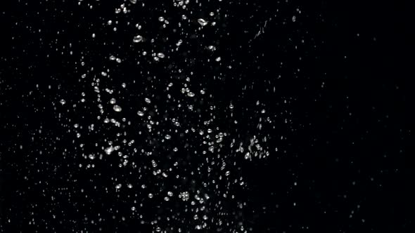 Slow Motion Stream of Water Drops Down in Aquarium on a Black Background