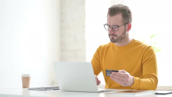 Man Making Successful Online Payment on Laptop