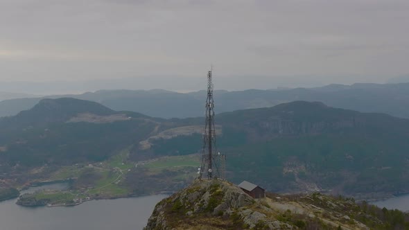 Aerial panoramic of scenic lookout, amazing Norwegian coastal landscape. Mast tower broadcasting rad