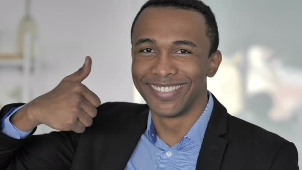 Thumbs Up By Casual Afro-American Businessman Looking at Camera
