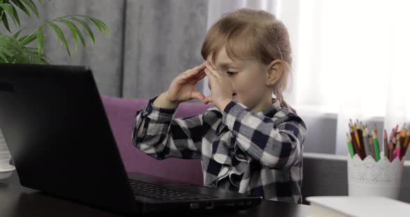 Girl Doing Lessons at Home Using Digital Laptop Computer. Distance Education