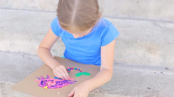 The Girl is Engaged in Creative Modeling From Plasticine