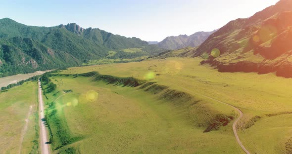 Aerial Rural Mountain Road and Meadow at Sunny Summer Morning