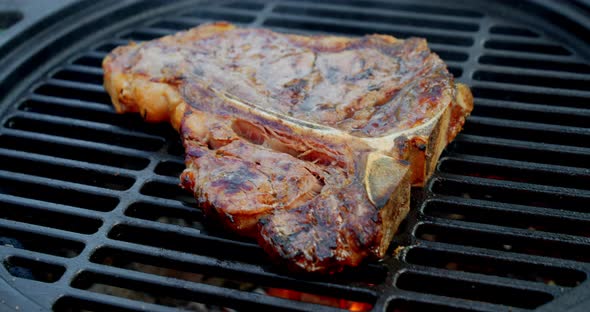 Steak T-bone Is Fried on a Barbecue. 