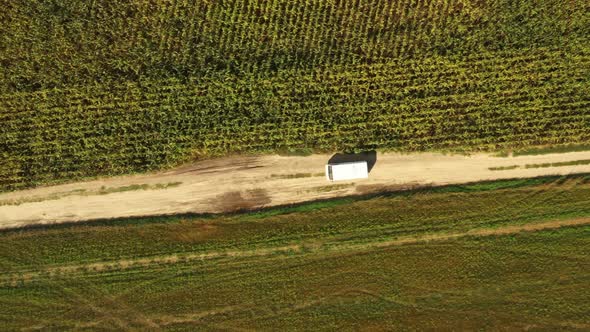 Elevated Top Flat View Of Van Car Vehicle Automobile Drive Motion On Countryside Road Through Summer