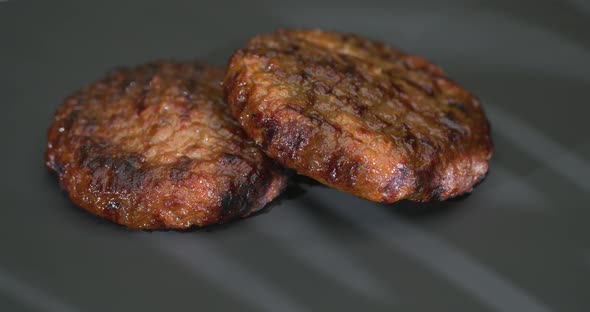 Grilled Two Hamburgers on the Background of Light Reflected from the Window.