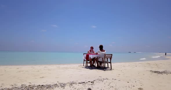 Romantic people after marriage in love spend quality time on beach on summer white sandy background 