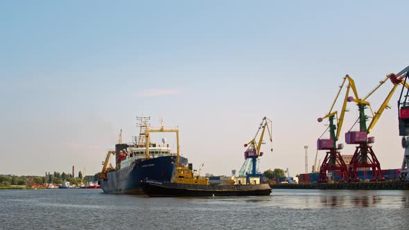 Tugboat towing a fishing trawler in port