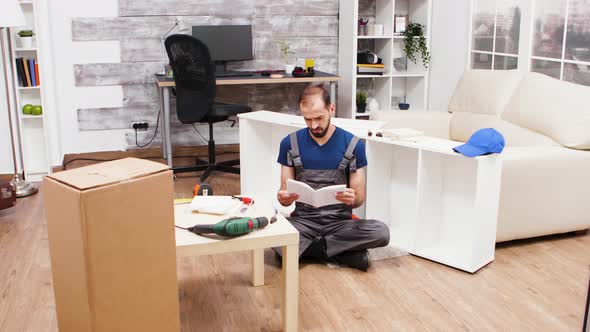 Confused Young Worker While Reading Instructions