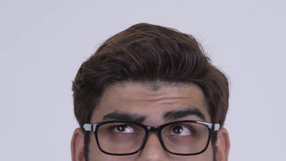 Eyes of Young Indian Hipster Man with Eyeglasses Thinking