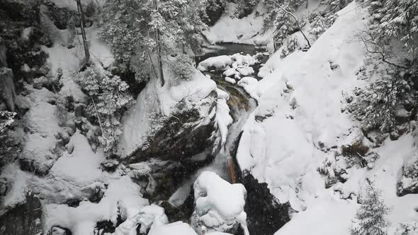 Waterfall in mountains in deep winter