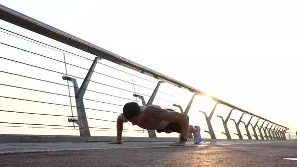 Strong Sportsman with Muscular Torso Do Pushups Outdoor Keep Fit