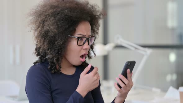 Portrait of African Woman Loss on Smartphone