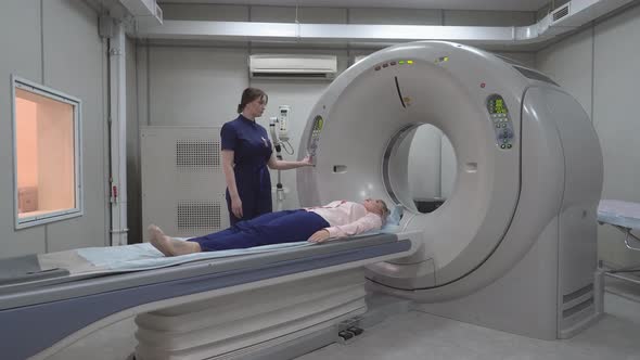 Female Patient On The Ct Or Mri Scanner Machine During X-Ray Process