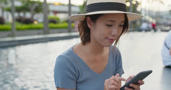 Woman use of mobile phone for online at outdoor