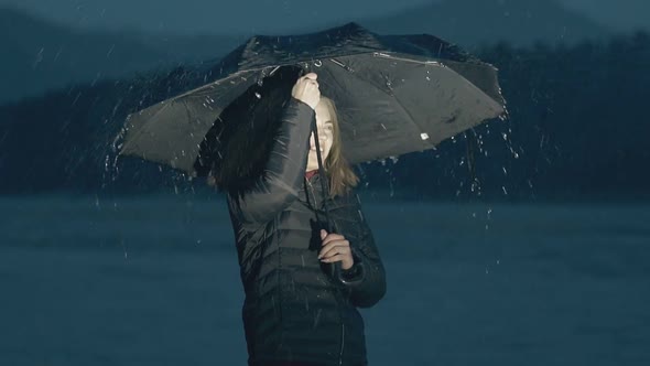 Emotional Girl with Umbrella Under Night Rain Slow Motion