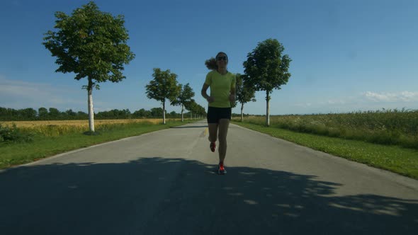 Happy Woman Running on Empty Street