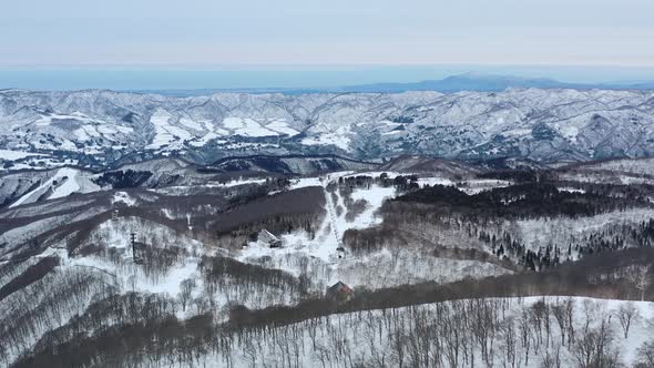 mountainous snowy landscape in nozawa onsen nagano japan during winter, aerial