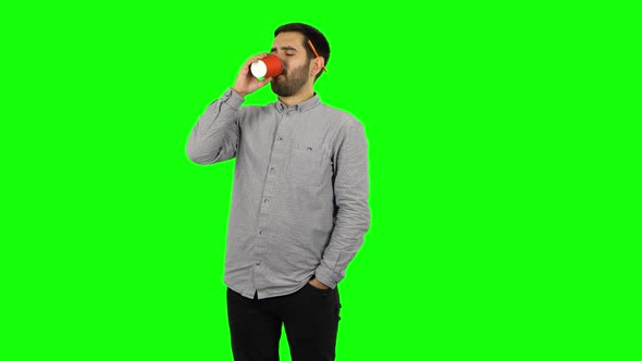 Brunette Guy Drinking Unpalatable Coffee and Is Disgusted. Green Screen