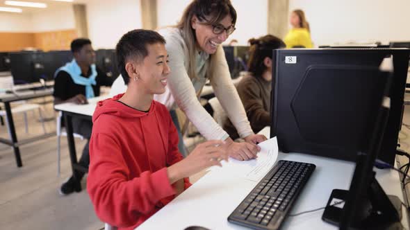 Young Asian student with teacher during university lesson in classroom