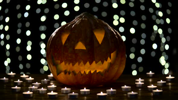 Halloween Pumpkin with Scary Face with with a Burning Candle