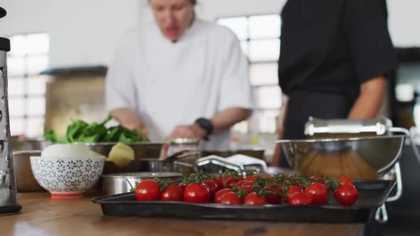 Caucasian female chef teaching diverse group