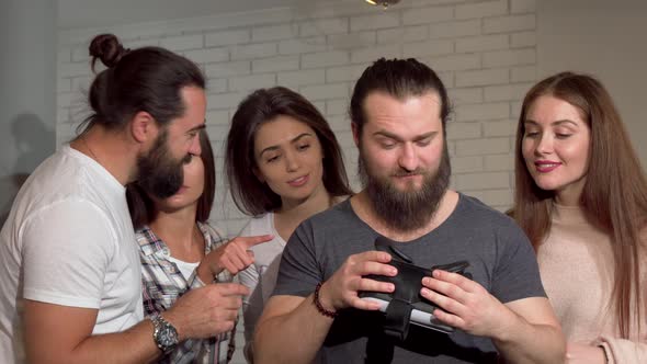 Bearded Man Using Virtual Reality Glasses with His Friends