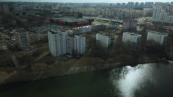 City block near the river. Multi-story houses. Water city system. Aerial photography.