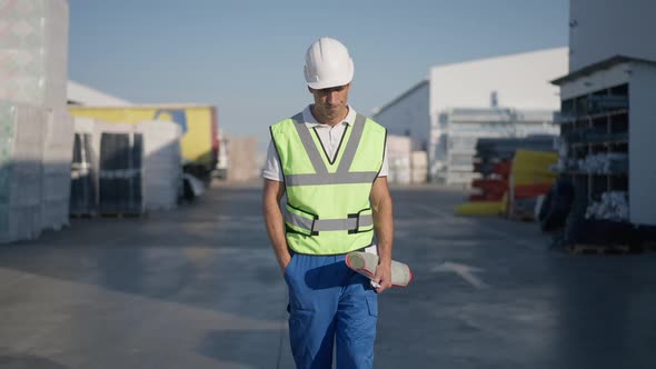 Troubled Stressed Middle Eastern Man in Hard Hat Walking at Outdoor Warehouse in Slow Motion