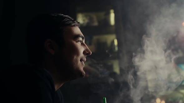 Close-up Handsome Guy Smokes Hookah and Has Fun with His Friends in Slow Motion