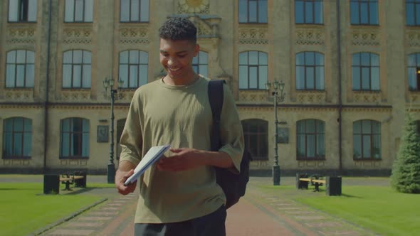 Happy Handsome African American Male College Student Going Home After Study