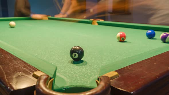 Billiard balls with numbers on a pool table. time lapse shot with slider