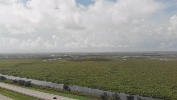 Florida Everglades, slow drone landing showing very wet conditions by the highway