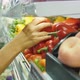 Young Vegan Woman Choosing Sweet Red Pepper in Supermarket. Female Hand Taking Vegetables From Shelf - VideoHive Item for Sale