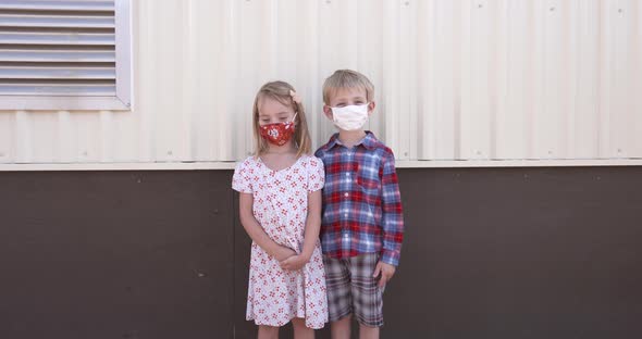 School kids wearing masks and demonstrating physical distancing.