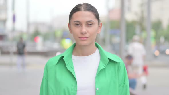 Portrait of Hispanic Woman Looking at the Camera Outdoor