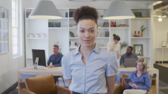 Young woman smiling to camera at the office