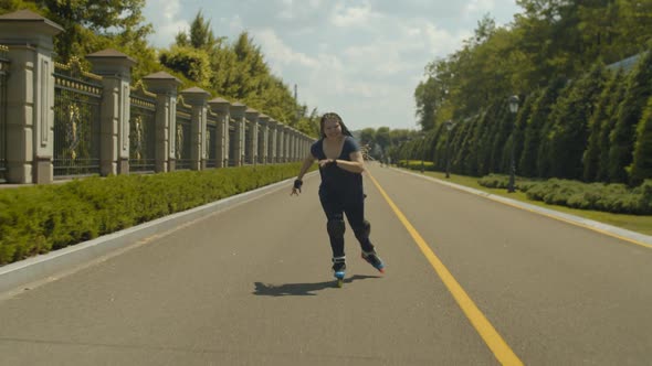 Happy Female Enjoying Speed and Wind Rollerblading