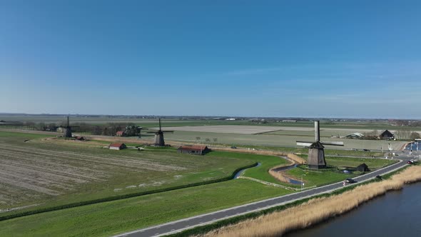 Historic Dutch Windmills in a Farm and Grass Field Landscape in The Netherlands Holland