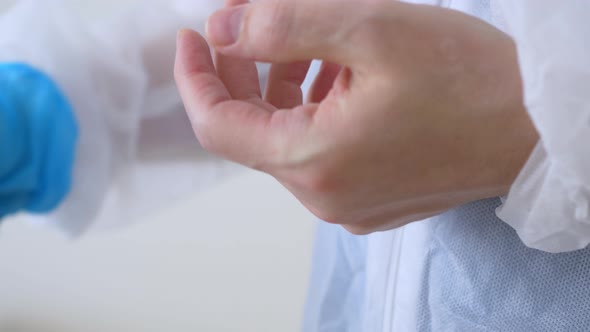 Closeup of Putting on Surgical Gloves