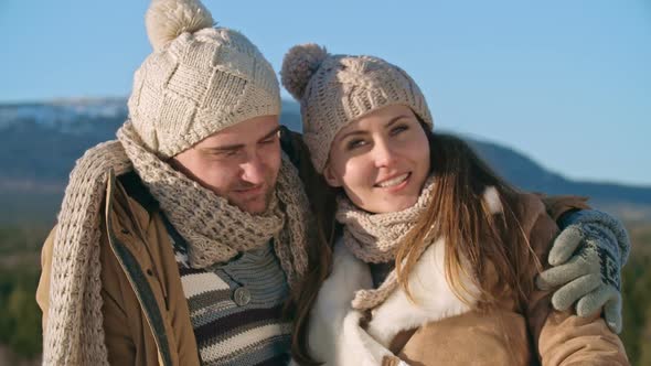 Smiling Couple Taking Winter Photos