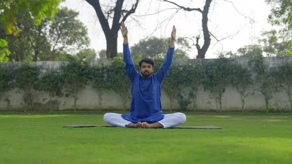 Advanced Yoga is being done by an Indian man in an Indian outfit Kurta Pajama