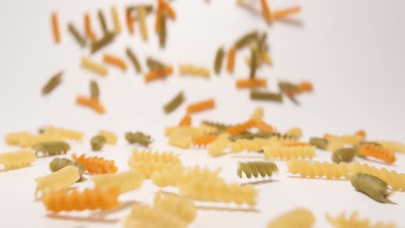 Stream Of Multi Colored Fusilli Pasta Moving To A Camera