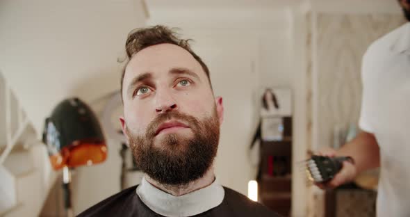 Handsome Man Getting New Hairstyle with Electric Trimmer